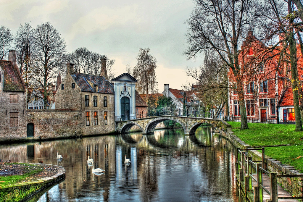 Belgian village with charming stone houses, cobblestone streets, and lush green surroundings